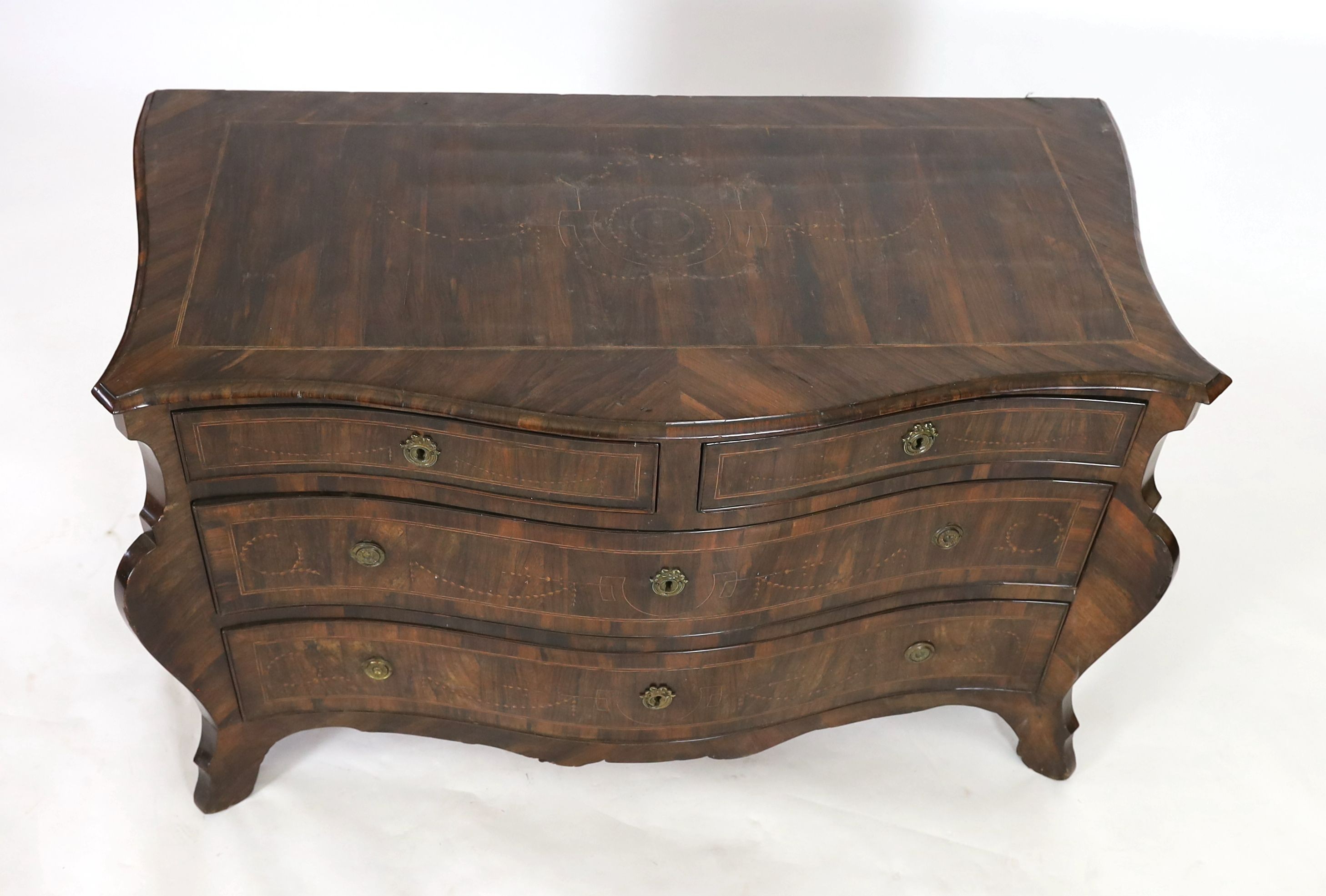 An 18th century North Italian marquetry inlaid kingwood serpentine commode, W.140cm D.67cm H.82cm